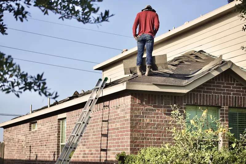 Professional roofer working on a residential roof in Dividing Creek